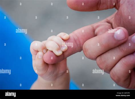 Newborn Hand Holding Father Finger Stock Photo Alamy