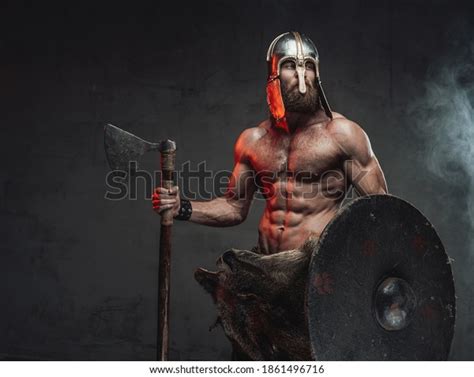 Handsome And Brutal Viking With Beard And Naked Torso With Helmet On