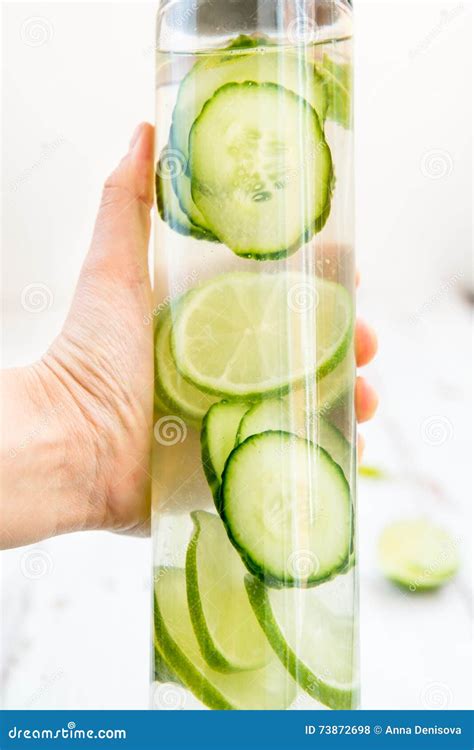 Detox Infused Water With Cucumber Lime And Mint In Bottle Stock Photo