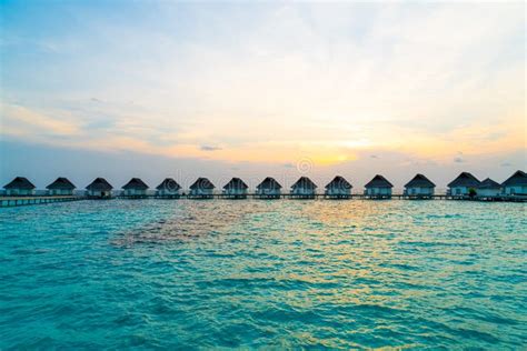 beautiful tropical sunset over maldives island with water bungalow in hotel resort stock image