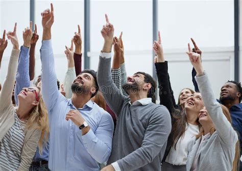 Group Of Diverse Young People Holding Their Hands Up Stock Photo