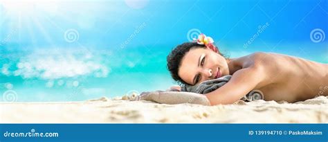 Beautiful Girl Lying Down Under The Sun Tanning In A Tropical Beach