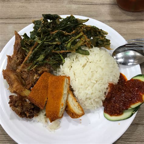 Nasi lemak (coconut base rice) is a popular dish in malaysia alongside nasi tomato ( tomato base rice). Penang Nasi Lemak? by Geraldine Ang | Burpple