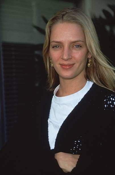 American Actor Uma Thurman Wearing A White Tshirt And A Black Sweater