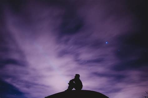 Free Photo Silhouette Of Sitting Man On A Hill Watching The Night Sky