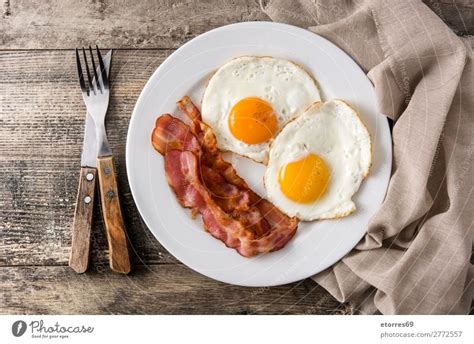 Fried Eggs And Bacon For Breakfast On Wood A Royalty Free Stock Photo
