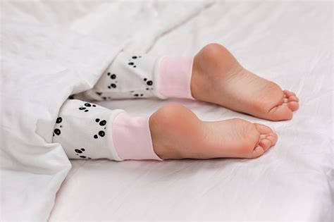 Pair Of Kid Bare Feet In Bed Stock Photo Download Image Now Istock