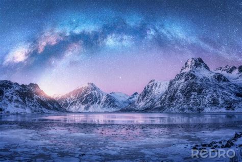 Fototapeta Milky Way Above Frozen Sea Coast And Snow Covered Mountains