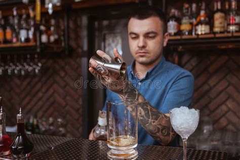 Handsome Male Tattooed Bartender Preparing A Drink Stock Image Image