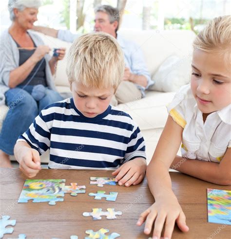 Children Playing Puzzle In The Living Room — Stock Photo