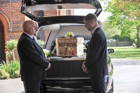 Most goth funeral ever attended by Grim Reaper and Morticia Addams