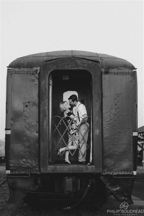 Black And White Photograph Of Two People Kissing In The Caboose Of A Train