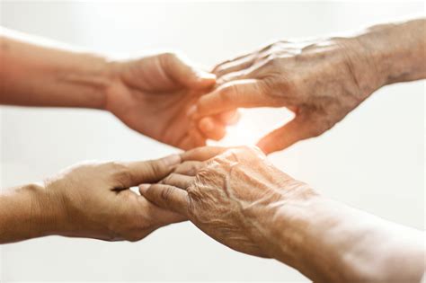 Close Up Hands Of Helping Hands Elderly Home Care Mother And Daughter