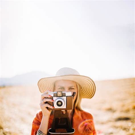 Free Photo Confident Woman Using Old Camera While Traveling