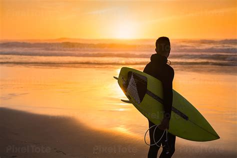 Male Surfer With A Surfboard Stock Photo Pixeltote