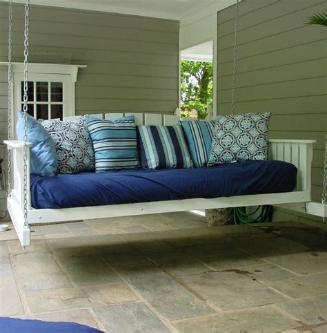 Chatham mahogany platform daybed storage outdoor platform bed with some storage, squat wooden construction, removable rattan baskets on bottom and cream mattress on top. Porches for Sleeping
