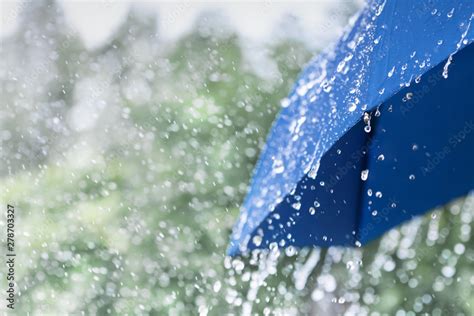 Blue Umbrella Under Heavy Rain Against Nature Background Rainy Weather