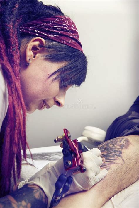 Female Artist Tattooing Man Calf With Tattoo Machine Stock Photo Image Of Creativity Comics