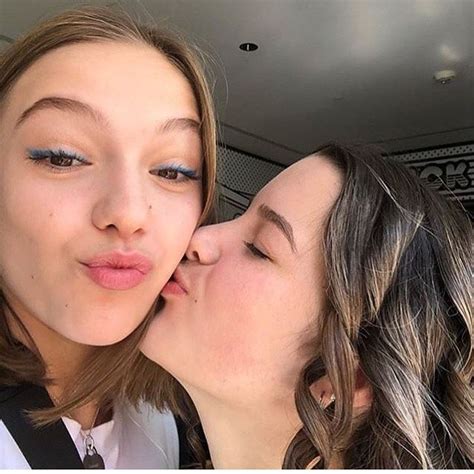 Two Women Are Kissing Each Other In The Back Of A Car With Their Eyes