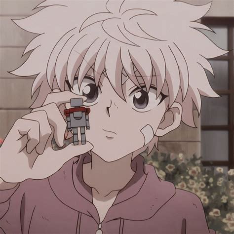 An Anime Character Holding A Small Robot In Front Of His Face