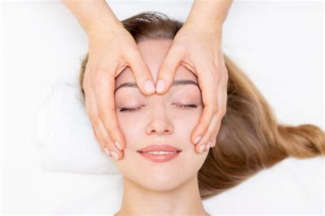 Premium Photo Young Woman Enjoying Massage In Spa Salon Face Massage Closeup Of Young Woman