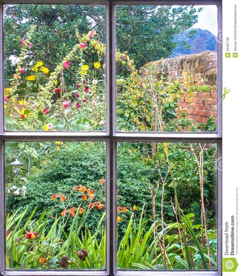 Cottage Garden Through An Old Sash Window Stock Photo