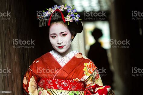 Geisha Women In Kimono Waiting In A Traditional Japanese Alleyway Stock