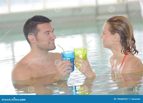 Couple Relaxing In Resort Swimming Pool Drinking Cocktails Stock Image Image Of Bikini