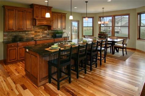 This kitchen features an almost black wooden flooring and cabinets. Cherry Kitchen Cabinets With Gray Wall And Quartz ...