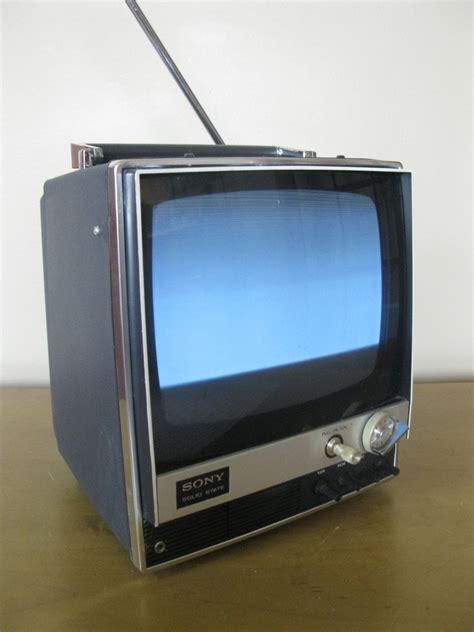 An Old Television Sitting On Top Of A Wooden Table