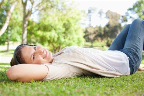 Woman Lying On The Grass While Listening To Music Stock Image Image