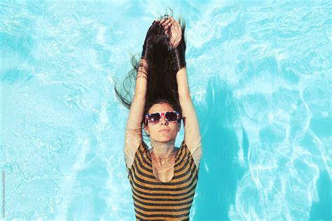 Relaxed Woman In A Swimming Pool By Stocksy Contributor Lucas Ottone