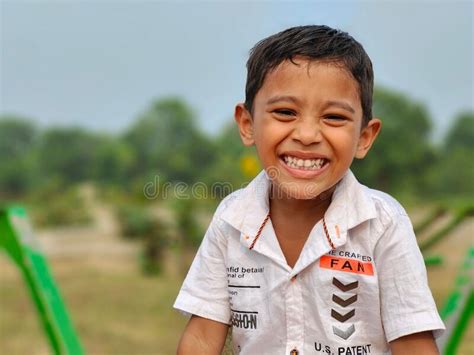 Portrait Of A Young Indian Boy Laughing While Looking At The Camera