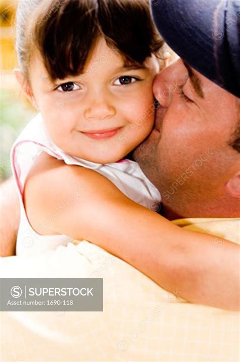 Portrait Of A Girl Hugging Her Father Superstock