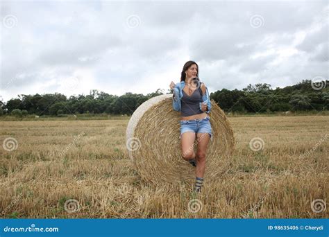 A Beautiful Young Woman Is Posing In The Field Stock Photo Image Of