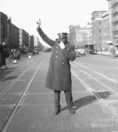 police raising his arm to direct traffic photograph by bettmann fine art america