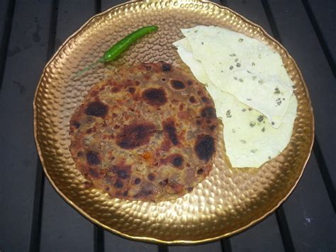 Sindhi Kokie and papad with a green chilie on the side