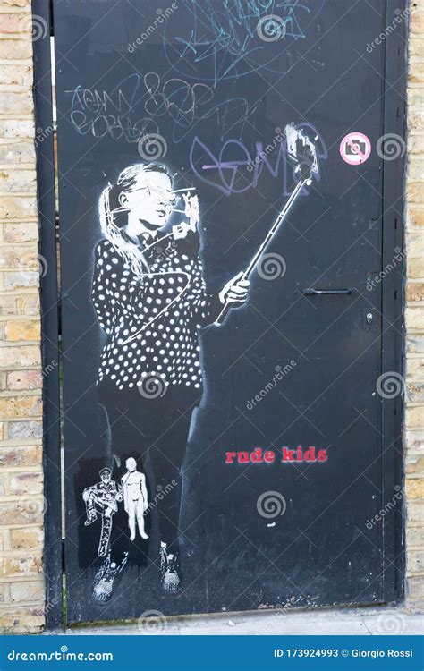 Graffito On A Metal Door Of A Girl Who Makes A Selfie With A Stick