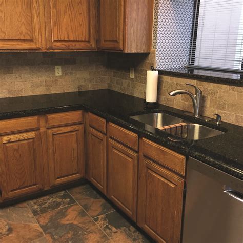 We kept the honey oak cabinets (hubby's decision, of course), and put in ubatuba granite, darkened the hardware, and took down a wall to make a peninsula between kit and dining. Uba Tuba Granite Countertops | Cost of granite countertops, Black granite countertops, Kitchen ...
