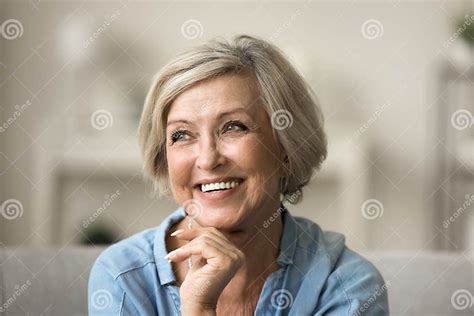Cheerful Pretty Older Woman With Trendy Hairstyle Touching Chin Stock