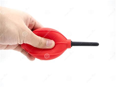 Hand Squeezing A Red Camera Air Blower Isolated On A White Background