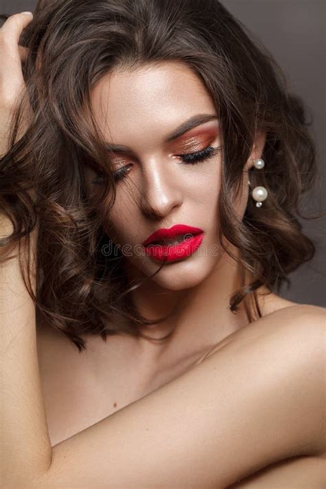 Luxury Brunette Model With Bright Professional Make Up Coral Eyeshadows Long Lashes And Red