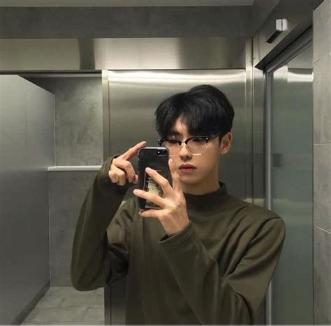 A Man Taking A Selfie With His Cell Phone In An Elevator Stall While