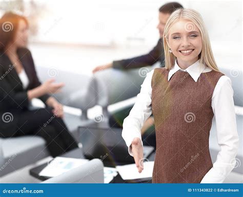 Young Business Woman Extending Her Hand To Meet The Customer Stock