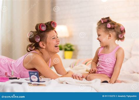 Mom And Daughter In The Bedroom On The Bed In The Curlers Make U Stock Image Image Of