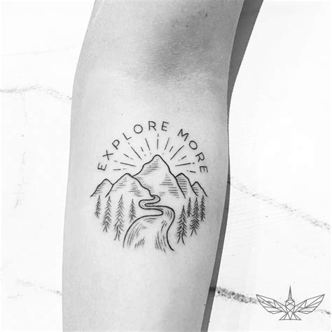 Tattoo Of A Mountainous Landscape With A River And A Quote ‘explore