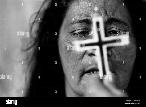 A Face Of A Colombian Woman Is Seen Behind The Crucifix During The