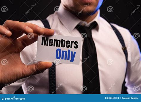 Businessman Putting A Card With Text Members Only In The Pocket Stock