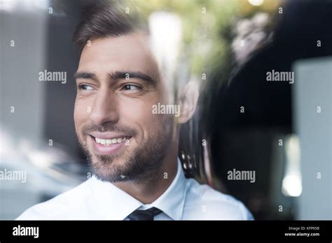 Smiling Businessman Looking Out Window Stock Photo Alamy