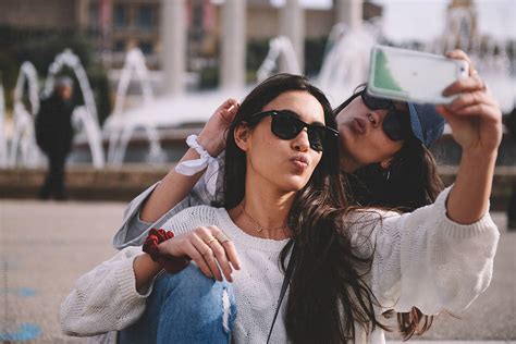 Two Friends Taking Selfie By Stocksy Contributor Guille Faingold